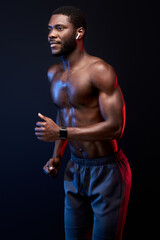 Fototapeta na wymiar confident black sportsman running, isolated on black background. muscular strong male engaged in sport, have athletic body