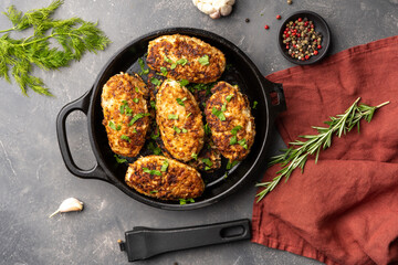 Meat cutlets in frying pan over background. Herbs and spices. Top view, flat lay. High quality photo