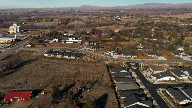 Over a residential area towards multiple ponds and custom homes