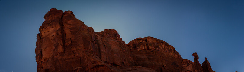 Fototapeta premium Close up of red sandstone massif against blue sky in Archen national park in Utah, america