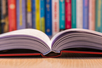 Opened book pages with blurred soft background of shelfbook