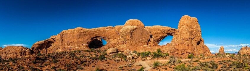 Panorama shot of red sandstone arches at summer sunny day in Arches national park in Utah, America