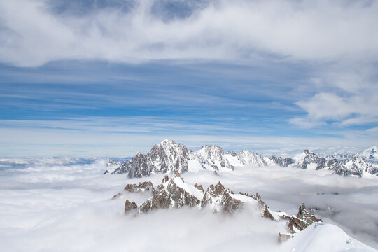 Top of French Alps Aiguille du Midi in Chamonix, France. Overlooking clouds and snow mountains