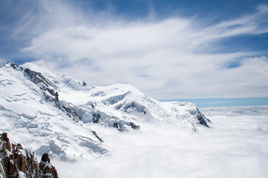 Top of French Alps Aiguille du Midi in Chamonix, France. Overlooking clouds and snow mountains