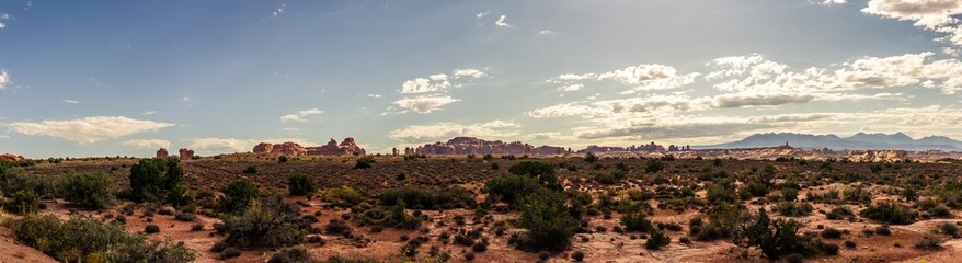 Fototapeta na wymiar Panorama shot of red sandstones monoliths in desert of Arches national park in Utah, america