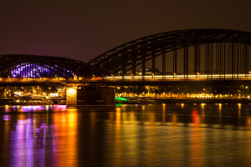 Fototapeta na wymiar Germany, North Rhine-Westphalia, Cologne. Bridge over the Rhine River at night.