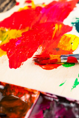 mixed on a wooden palette of multi-colored paints