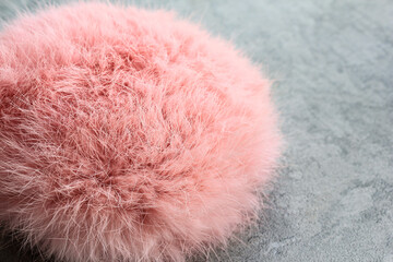 Fluffy fur headphones lie on a gray background.Pink eco-fur was used for the creation.