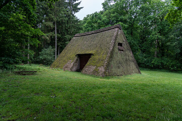 Fototapeta na wymiar Characteristic stable for German moorland sheep with a straw roof in the natural preserve Lueneburger Heide