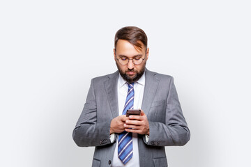 Image of businessman in eyeglasses using mobile phone isolated by white background 