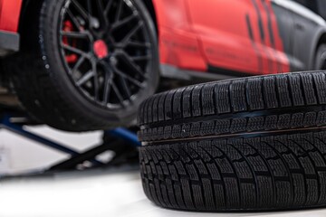 Changing car tire and wheel in the professional car mechanical service