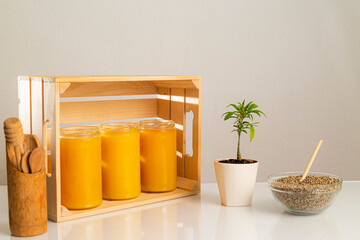 Jars of CBD honey, marijuana plant and hemp seeds