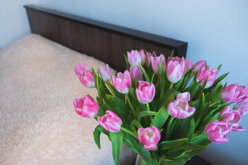 pink tulips on the background of the room