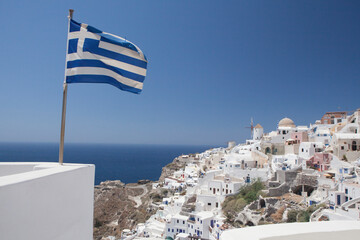 Greece, Santorini, Ia. Greek flag and Aegean Sea.