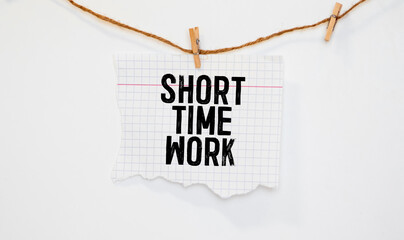 torn paper revealing a document with the text SHORT TIME WORK