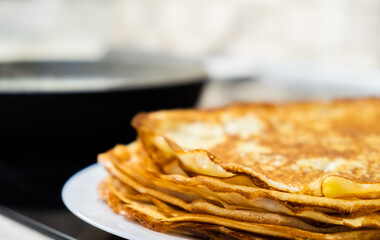a stack of pancakes on a white plate
