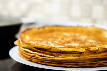 a stack of pancakes on a white plate