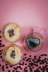 Two cups of coffee. Postcard for women's day on March 8. Trendy pink background. March 8 and the concept of Women's Day .Vertical view