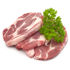 Raw pork neck chop meat with parsley herb leaves garnish isolated on white background cutout