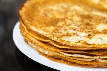 a stack of pancakes on a white plate