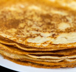 a stack of pancakes on a white plate