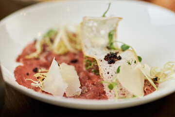 Thin slices of fresh jamon served on plate