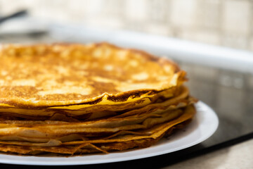 a stack of pancakes on a white plate