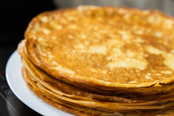 a stack of pancakes on a white plate