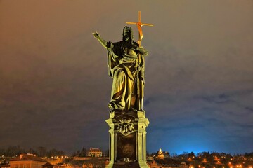 Fototapeta premium Statue of Saint John the Baptist on Charles Bridge in Prague, Czech Republic, by night.