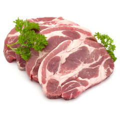 Raw pork neck chop meat with parsley herb leaves garnish isolated on white background cutout