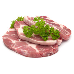 Raw pork neck chop meat with parsley herb leaves garnish isolated on white background cutout