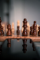 Chess pieces set up ready to play chess game on a wooden board strategy game