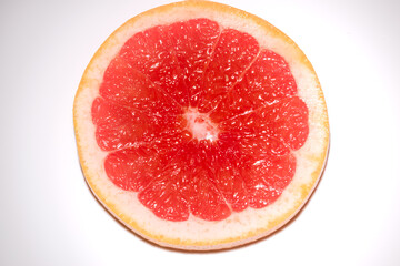 round slice of a grapefruit isolated on white background. Round slice of fresh fruit.