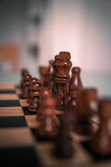 Chess pieces set up ready to play chess game on a wooden board strategy game