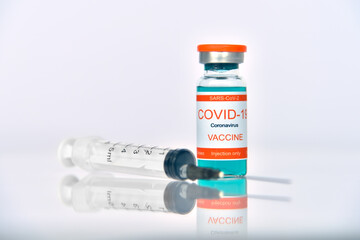Ampoule with covid-19 vaccine and syringe injection.