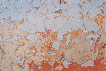 Old painted wall with cracked paint.