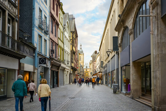 Fototapeta Tourists enjoy a stroll along the shops on the Rue du Gros Orloge in Rouen France with the astronomical clock in the background.