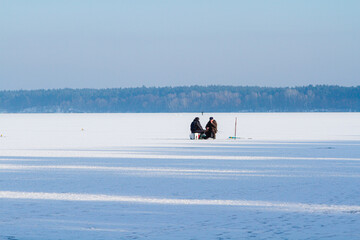 Winter ice fishing on the lake on a frosty day.