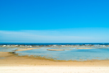 Fototapeta na wymiar seashore, in the photo sea water against the blue sky
