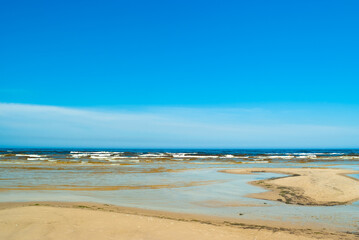 Fototapeta na wymiar seashore, in the photo sea water against the blue sky
