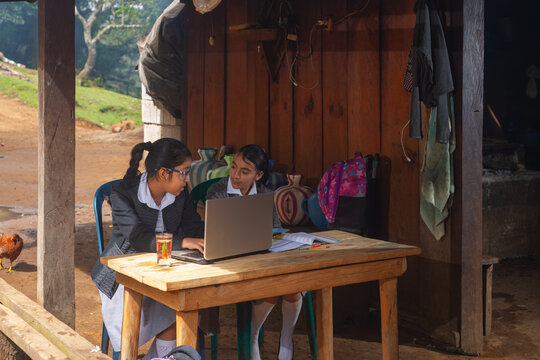 Girls in rural areas receive distance education, using a laptop.