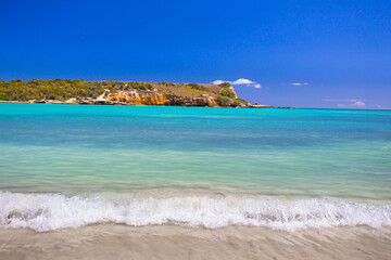 Idyllic beach scene with clear blue water, blue sky and sandy shore seen from Puerto Rico