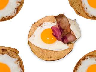 Homemade fried egg sunny-side on bagel cut-out on white backgrounds