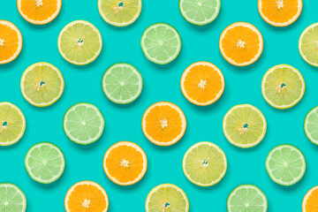 Citrus Fruit pattern on blue background. Orange, Lime, Lemon slices background. Flat lay, top view.