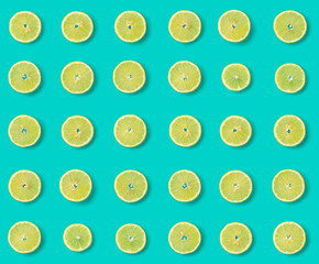 Fototapeta premium Fruit pattern of lemon slices on blue background. Flat lay, top view. Seamless pattern.