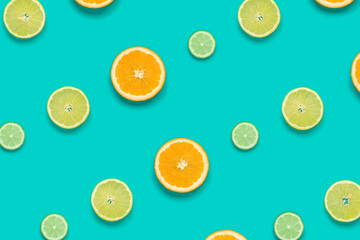 Citrus Fruit pattern on blue background. Orange, Lime, Lemon slices background. Flat lay, top view.