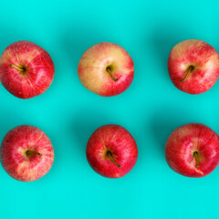 Fruit pattern of red apple on blue background. Flat lay, top view. Pop art design, creative summer concept. Food background.
