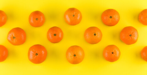 Fruit pattern of mandarin isolated on yellow background. Tangerine. Flat lay, top view.