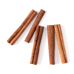 Cinnamon sticks isolated on white background closeup. Canella spice. Aromatic condiment background. Flat lay, top view.
