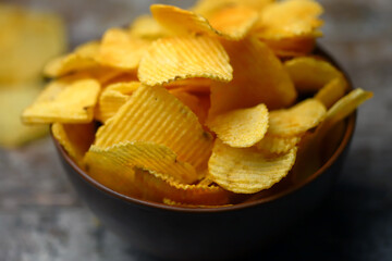 Cheese chips in a bowl. Yellow cheese chips.